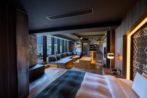 a hotel room with a bed and a living room at The Tower Hotel Nagoya in Nagoya