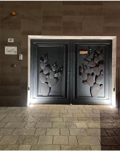 two glass doors with animal designs on them at Rescio's Rooms in Cavallino di Lecce