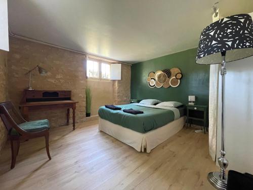 une chambre avec un lit, un bureau et une chaise dans l'établissement La Gaviota - gîte familial Le Bugue, au Bugue