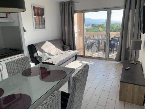 un salon avec une table et des chaises et un balcon dans l'établissement Mer et commerces 2 lits 1p 483, à Cannes