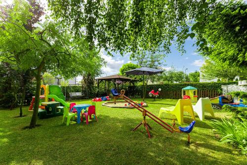 a playground with colorful chairs and an umbrella at Willa Rodos II in Władysławowo