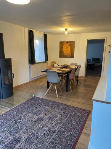 a dining room with a table and chairs and a rug at #7 Doppelzimmer mit Gemeinschaftsbad in Memmingen