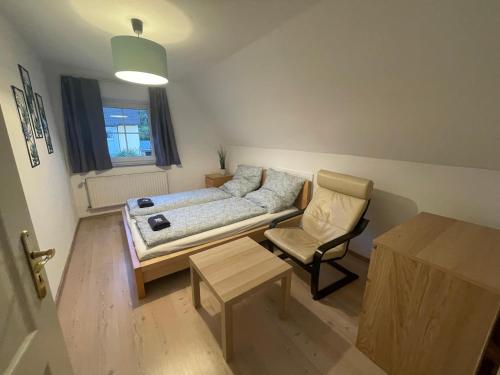 a living room with a couch and a chair at #7 Doppelzimmer mit Gemeinschaftsbad in Memmingen