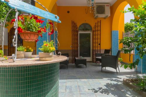 a patio in a building with flowers in pots at La Casa di Bianca in Follonica