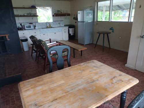 a kitchen with a table and chairs and a refrigerator at Adorable 2-bedroom stay with Balcony in Almirante