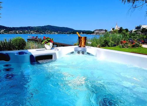 a large plunge pool with a view of the water at Haus am See in Maria Wörth