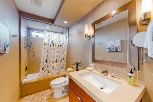 a bathroom with a sink and a toilet and a mirror at Canyon Shores Desert Escape in Cathedral City