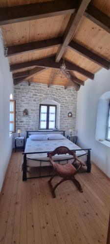 a bedroom with a large bed in a brick wall at Villa Olive Old Qeparo in Qeparo
