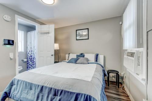a bedroom with a bed with blue and white sheets at Downtown Olde Town Arvada- Across from light rail in Arvada