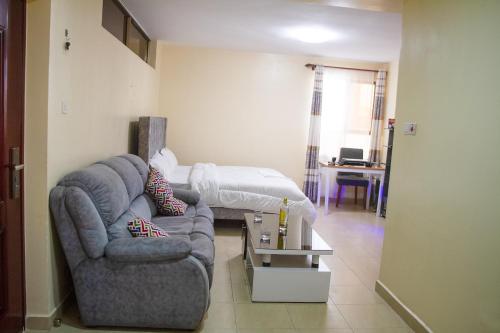 a living room with a couch and a bed at Feels Like HOME! in Nairobi
