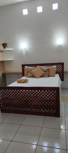 a bed with pillows on it in a room at Pousada La Luna in Paracuru