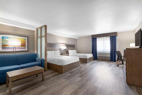 um quarto de hotel com duas camas e um sofá azul em Best Western Plus Downtown North em San Antonio