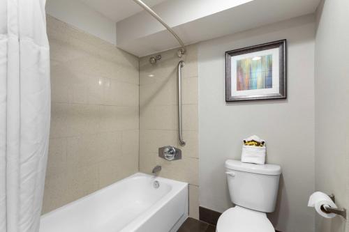 a bathroom with a white tub and a toilet at Best Western Plus Downtown North in San Antonio