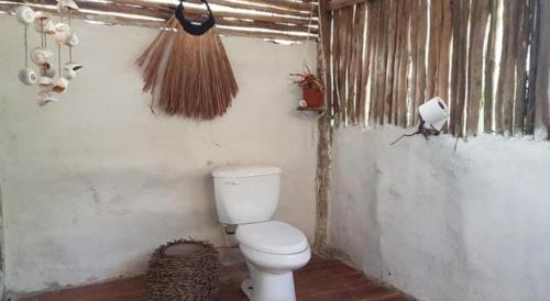 a bathroom with a white toilet in a room at Ecolodge Uh May in Francisco Uh May