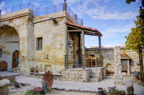 an old stone building with a balcony on it at Gibos Cave Hotel in Urgup