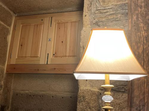 a lamp sitting next to a cabinet in a room at Quintal do Grémio in Torre de Moncorvo
