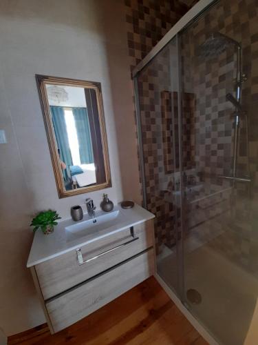a bathroom with a sink and a shower at Casa da Varanda in Carreço