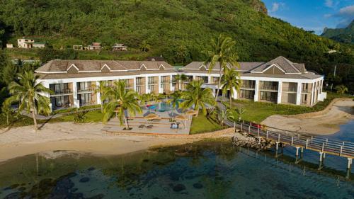 an aerial view of a resort on the beach at Cook's Bay Hotel & Suites in Paopao