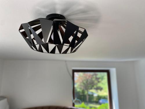 a black and white pendant light hanging from a ceiling at Ardenne in Spa
