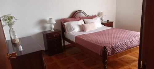 a bedroom with a bed and two night stands at Vista do Pilar in Conceição