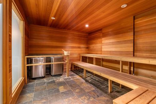 a sauna with wooden walls and benches and a washer and dryer at Regent Hotel Revelstoke in Revelstoke