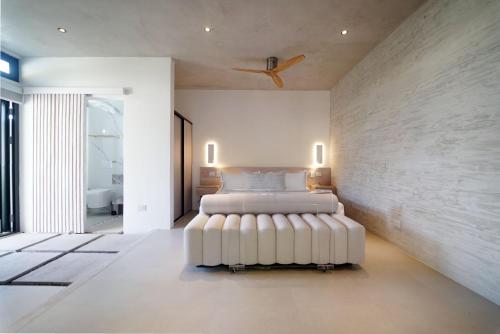 a bedroom with a bed in the middle of it at KUNUK- Walk to Hermosa beach in Santa Teresa Beach