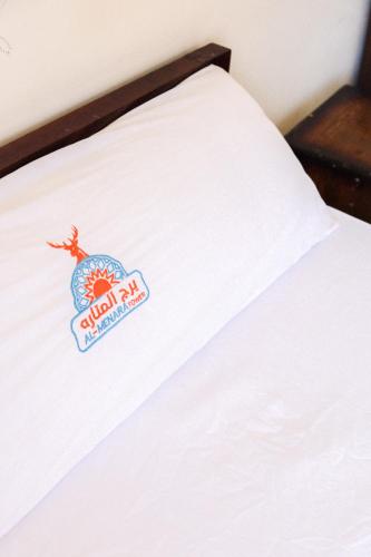 a close up of a bed with a sign on it at Al-Manara Hostel Siwa Oasis in Siwa