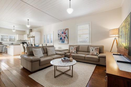 a living room with a couch and a table at Sampson Cottage - Historic Charm in Orange