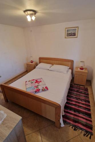 a bedroom with a bed and two night stands at Apartments by the sea Zuronja, Peljesac - 13202 in Putniković