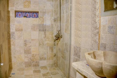 a bathroom with a shower with a sink at Gibos Cave Hotel in Urgup