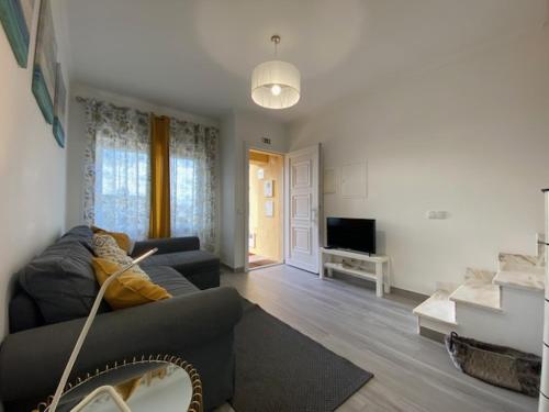 a living room with a couch and a television at Casa da Formosa in Silveira