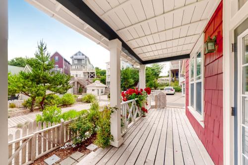 a house with a wooden porch with flowers on it at Olivia's Rose in Lincoln City