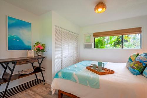 a bedroom with a bed with a tray on it at Kamahana 16 - downstairs in Princeville