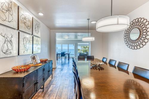 a dining room with a large wooden table and chairs at Oceanside Skies in Oceanside