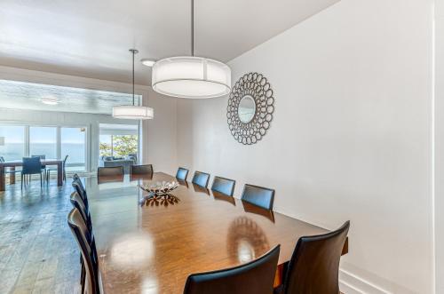 a dining room with a long table and chairs at Oceanside Skies in Oceanside
