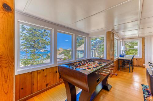 a room with a foosball table in a room with windows at Oceanside Skies in Oceanside