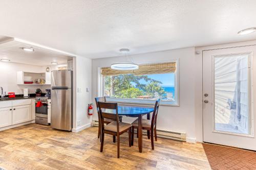 a kitchen with a table and chairs and a window at Oceanside Skies in Oceanside