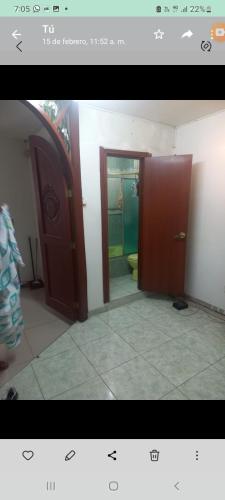 a bathroom with two open doors and a toilet at Apartamento en avenida sexta de Cali in Cali