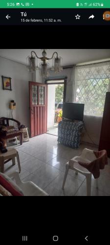 a living room with a laptop computer on a couch at Apartamento en avenida sexta de Cali in Cali