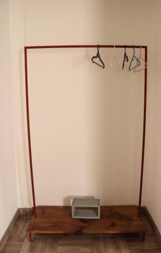 a room with a wooden table and hangers on a wall at Catre de mi corazón in Xalapa