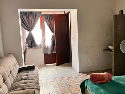 a living room with a couch and a window at Catre de mi corazón in Xalapa