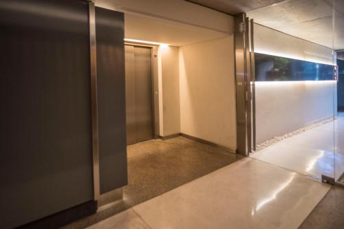 an elevator corridor with a door in a building at Grid Suites Charcas in Buenos Aires