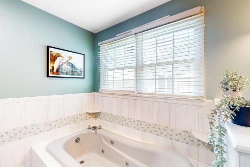 a bathroom with a tub and a window at Brandywine Home in the Pines in Ocean Pines