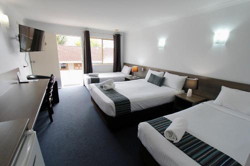 Postel nebo postele na pokoji v ubytování Sugar Country Motor Inn