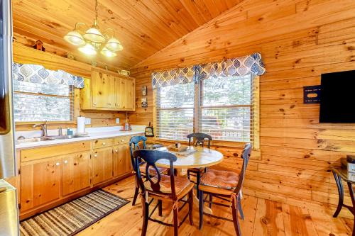 a kitchen with a table and chairs in a cabin at Sunset Peak in Cherry Log