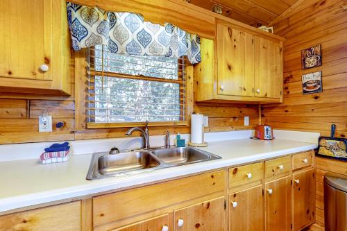 a kitchen with a sink and a window at Sunset Peak in Cherry Log