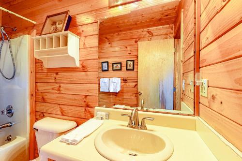 a bathroom with a sink and a toilet and a mirror at Sunset Peak in Cherry Log