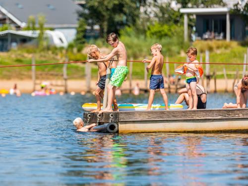 a group of children on a boat in the water at Chalet by Beach and Harbor with Terrace in Well