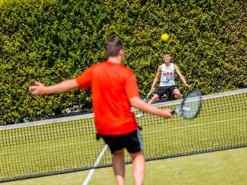 two men playing tennis on a tennis court at Chalet by Beach and Harbor with Terrace in Well