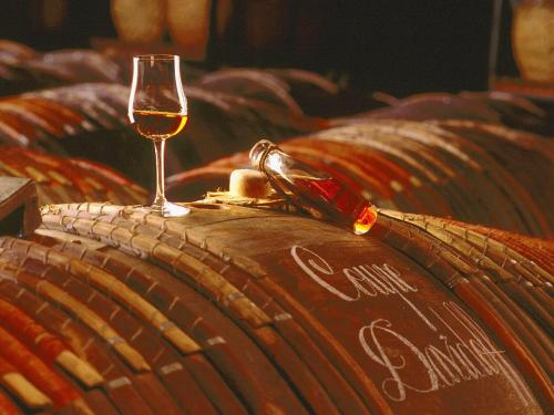 a glass of wine sitting on top of a barrel at Luxury Villa in France with Pool and Garden in Vasles